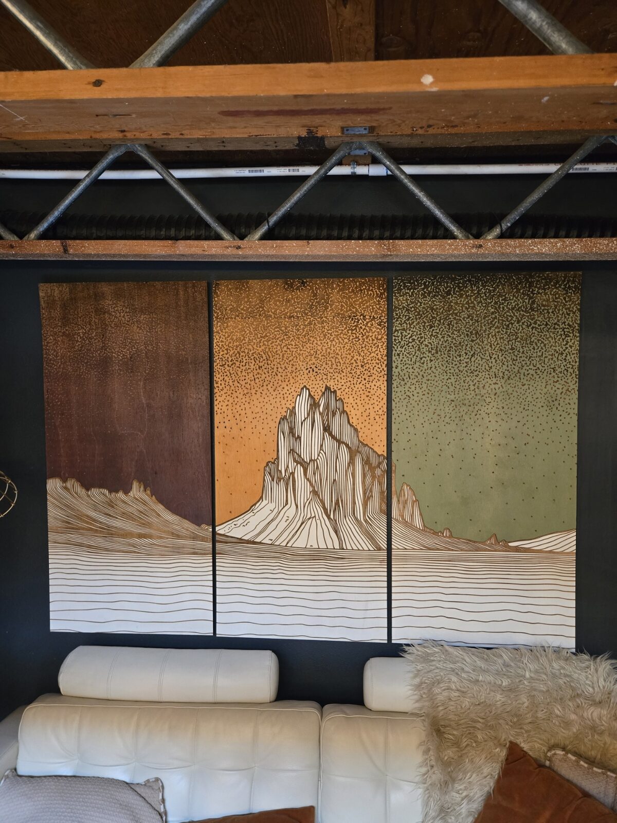 A triptych hung on the wall